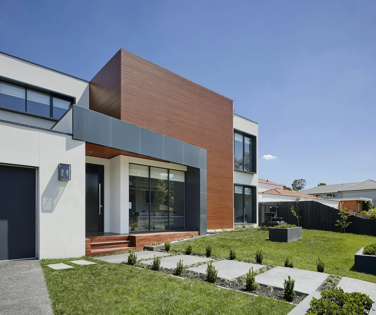 Paver driveway leading to a contemporary home garage